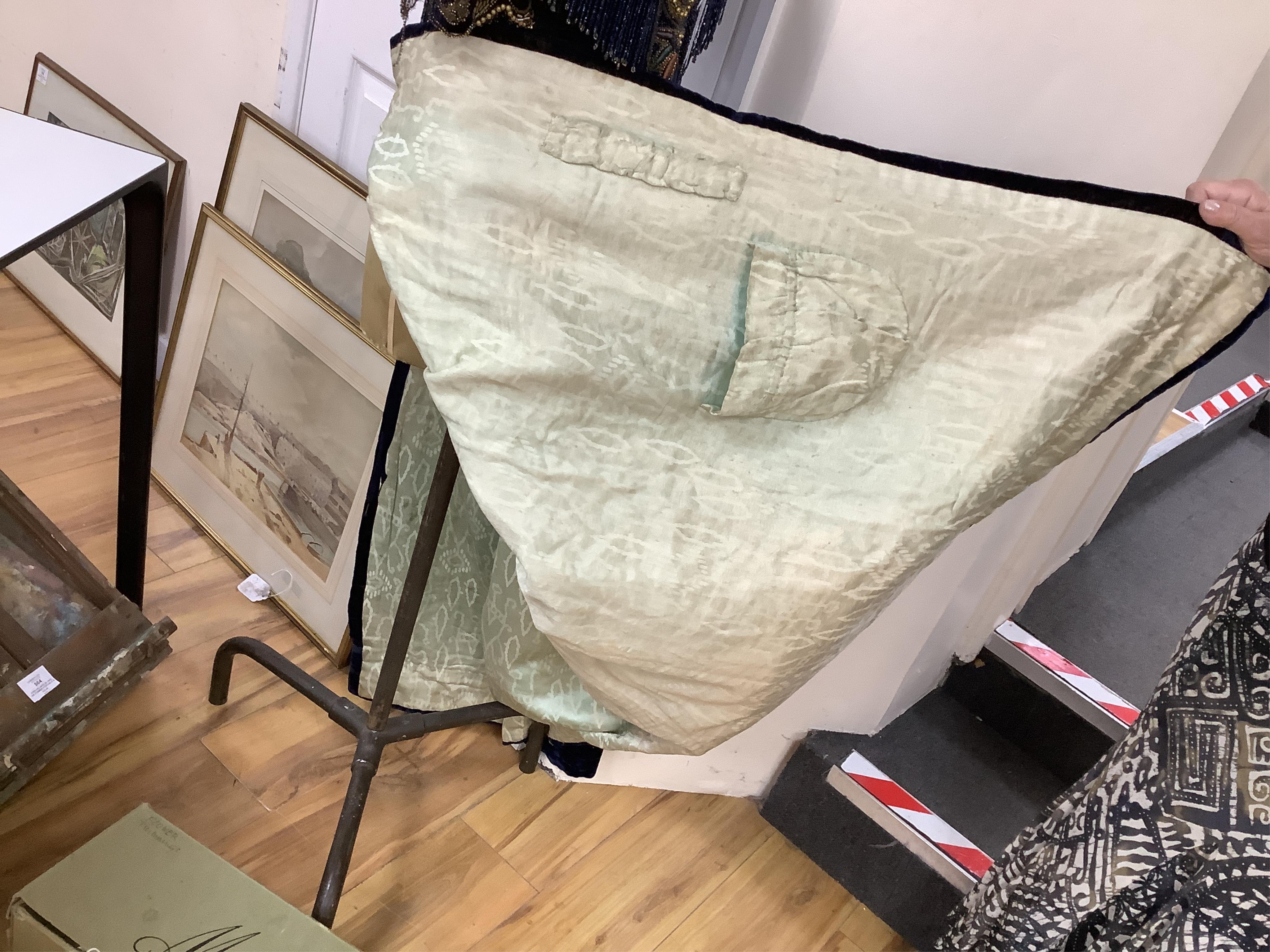 A 19th century ladies silk velvet matching long sleeved jacket/bodice, and skirt, together with another matching short sleeved bead worked bodice and white feather headdress.(4). Cape 106cm long. Condition - Both bodices